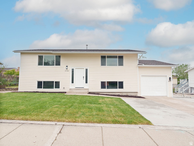 3784 Paine Road Magna, UT 84044 - Photo 1 of 1 Raised ranch with an attached garage, a front lawn, and concrete driveway