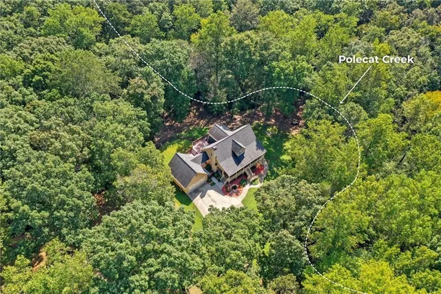 an aerial view of a house with a yard and street view