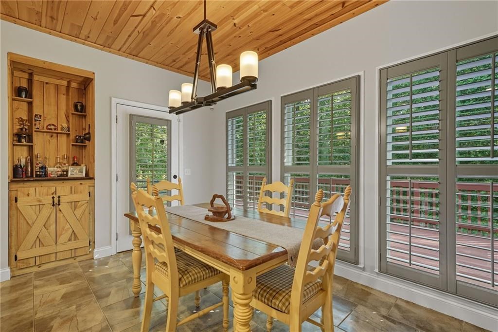 491 Hyde Road Jasper, GA 30143 - Photo 12 of 60 a dining room with furniture a chandelier and wooden floor