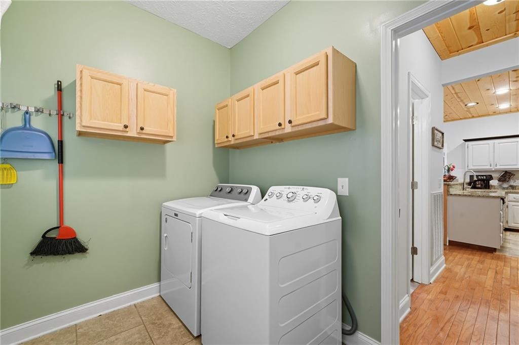 491 Hyde Road Jasper, GA 30143 - Photo 14 of 60 a utility room with cabinets washer and dryer