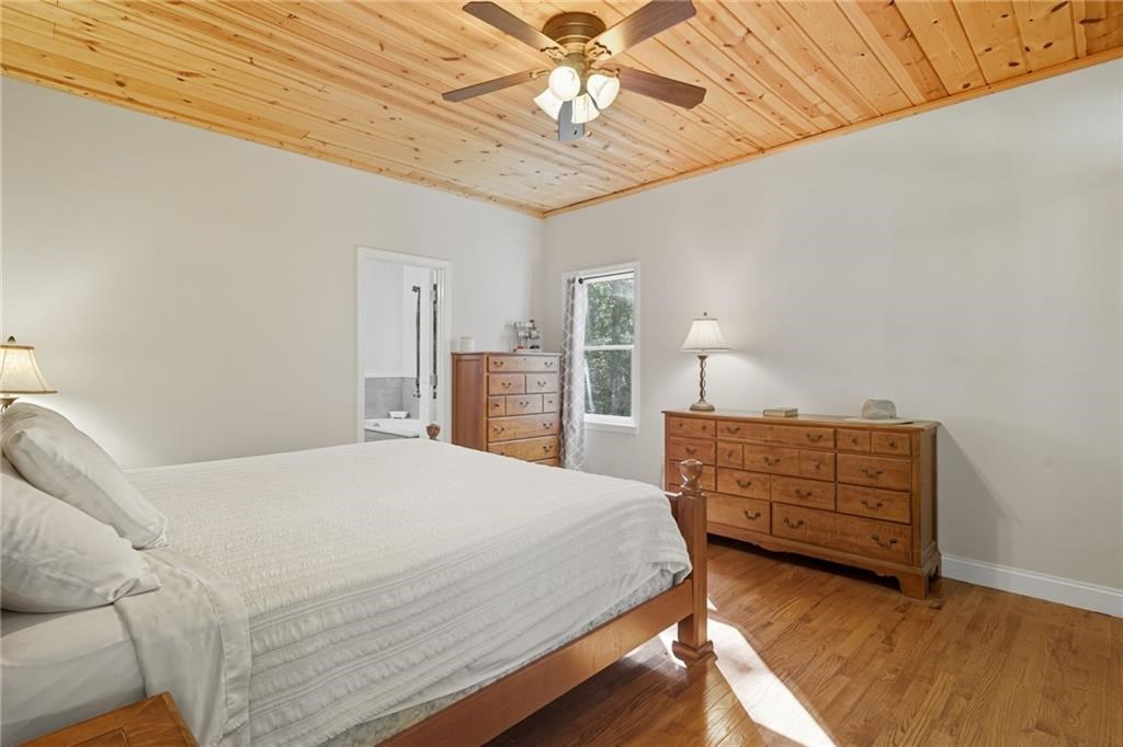 491 Hyde Road Jasper, GA 30143 - Photo 17 of 60 a bedroom with a bed and a chandelier