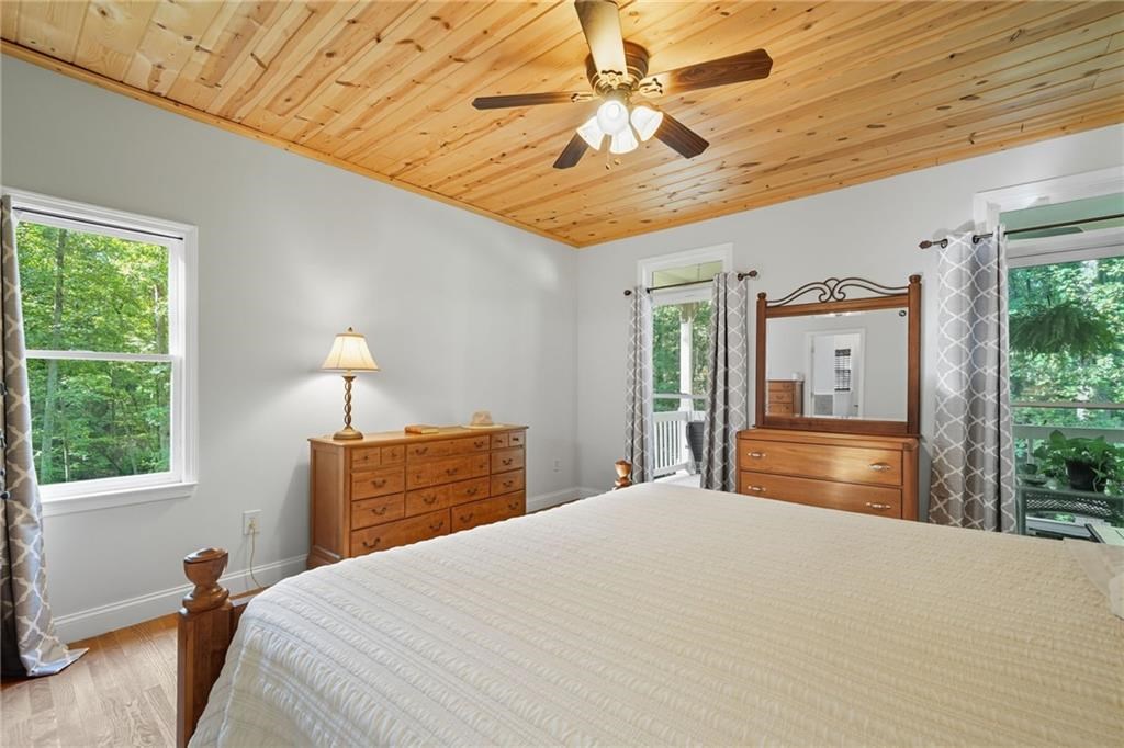491 Hyde Road Jasper, GA 30143 - Photo 22 of 60 a bedroom with a bed and wooden floor
