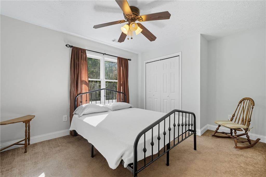 491 Hyde Road Jasper, GA 30143 - Photo 24 of 60 a bedroom with a bed and a chandelier