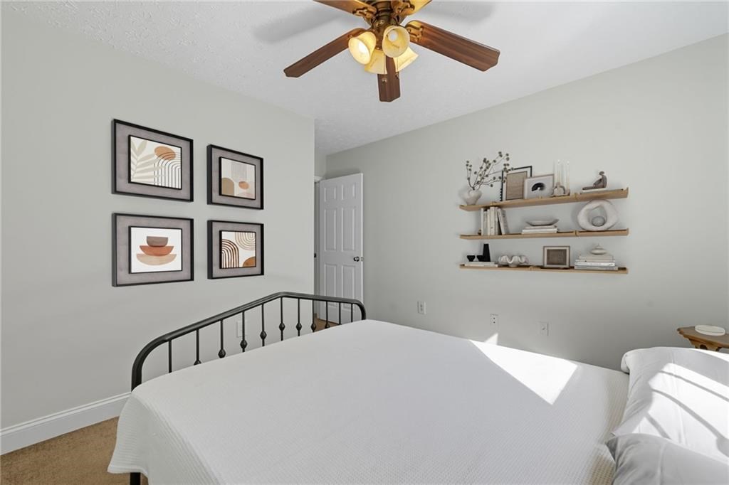 491 Hyde Road Jasper, GA 30143 - Photo 25 of 60 a bedroom with a bed and a chandelier