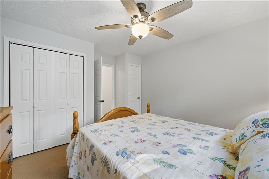 491 Hyde Road Jasper, GA 30143 - Photo 31 of 60 a bedroom with a bed and a chandelier