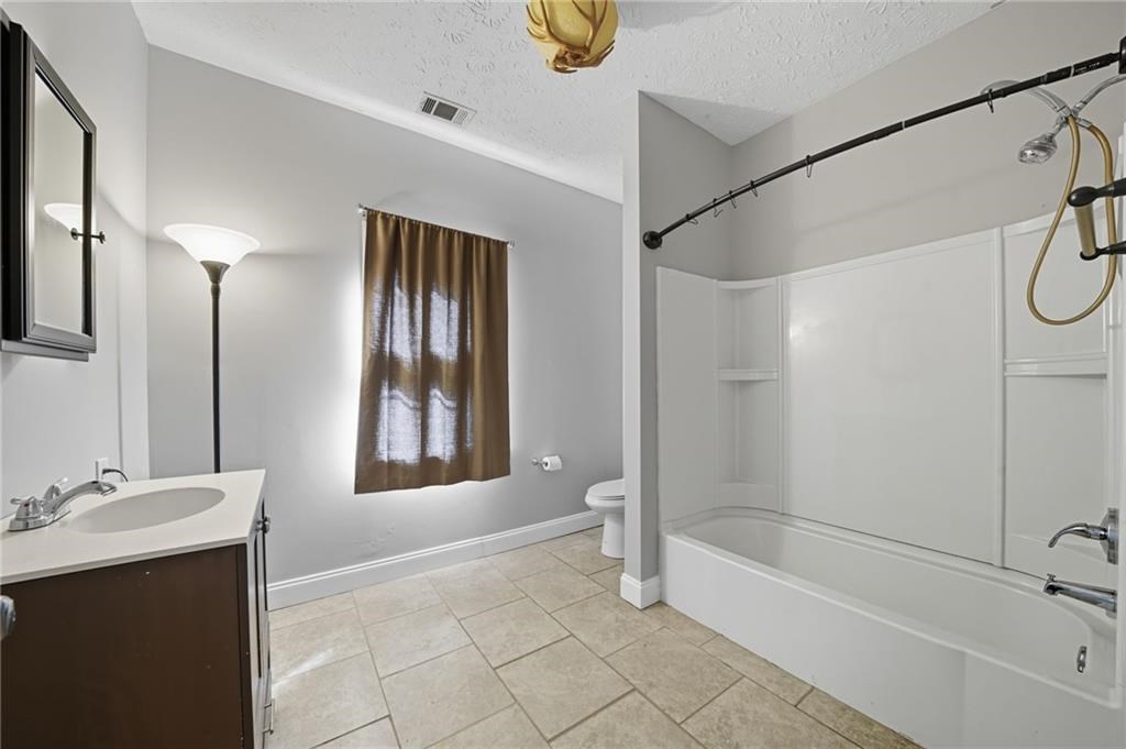 491 Hyde Road Jasper, GA 30143 - Photo 40 of 60 a bathroom with a bathtub and a shower