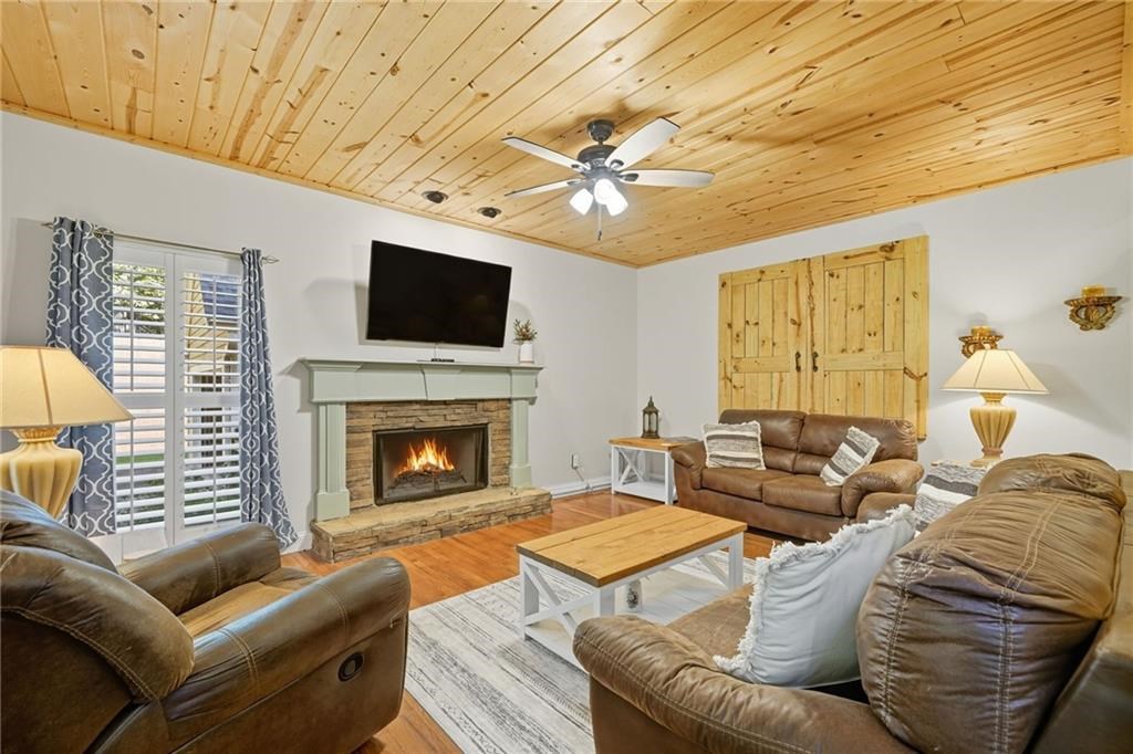 491 Hyde Road Jasper, GA 30143 - Photo 5 of 60 a living room with furniture a flat screen tv and a fireplace