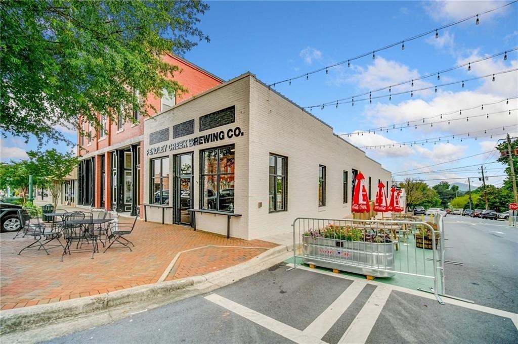491 Hyde Road Jasper, GA 30143 - Photo 54 of 60 a view of a patio with table and chairs potted plants and large tree