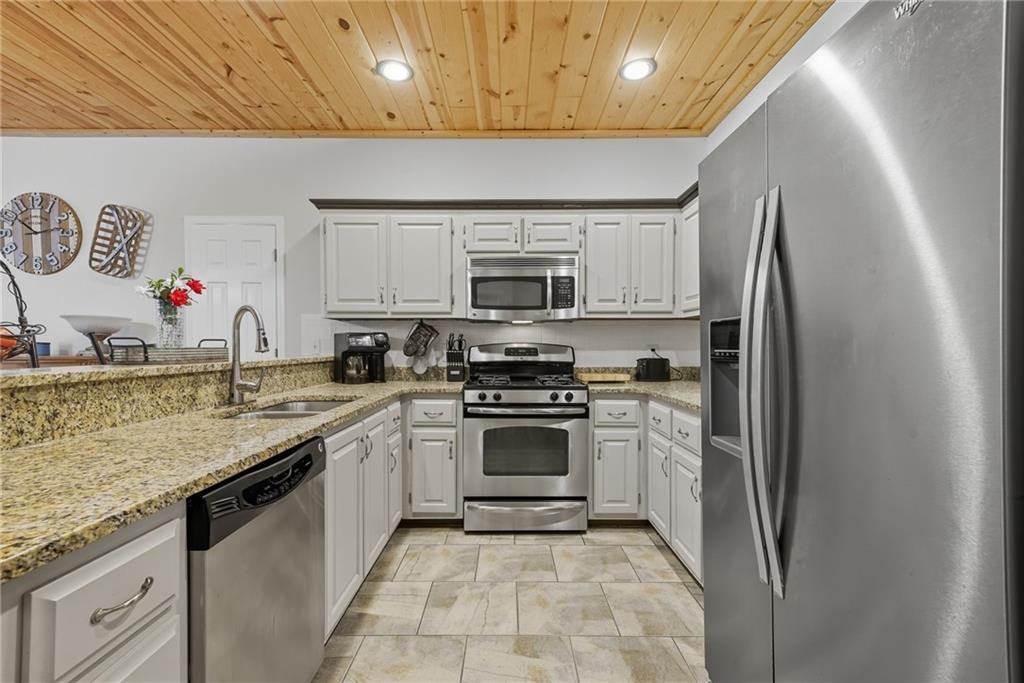 491 Hyde Road Jasper, GA 30143 - Photo 9 of 60 a kitchen with stainless steel appliances granite countertop a sink stove and refrigerator