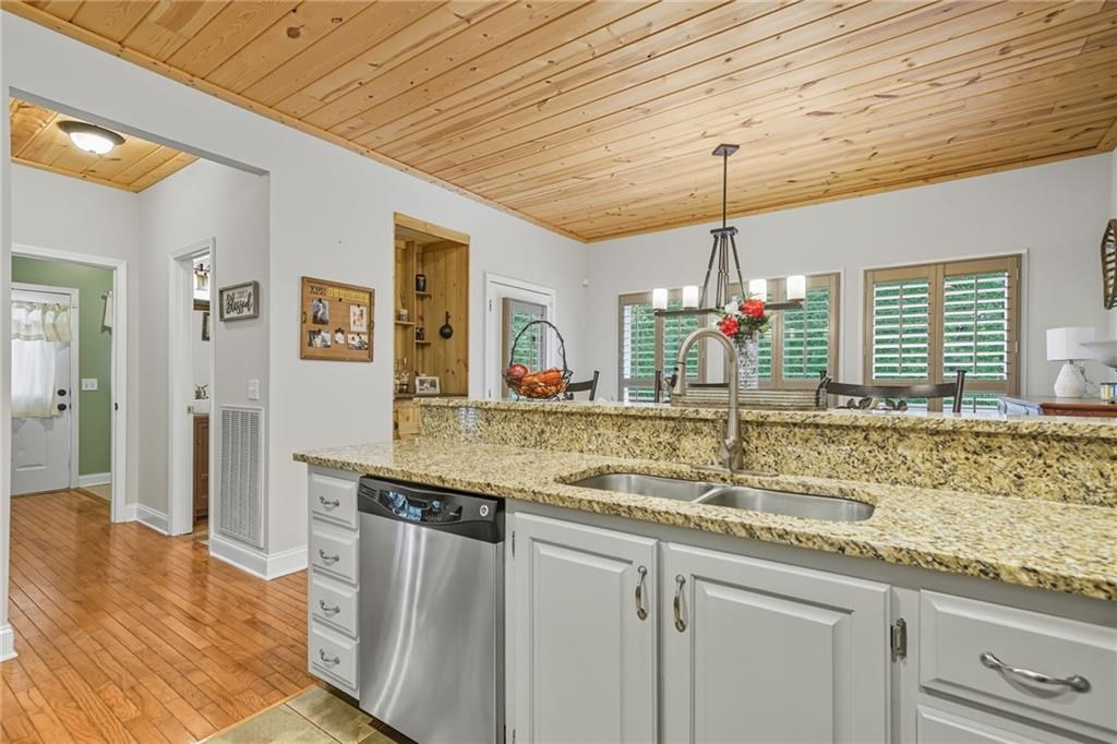 491 Hyde Road Jasper, GA 30143 - Photo 10 of 60 a kitchen with granite countertop a sink and a wooden floor