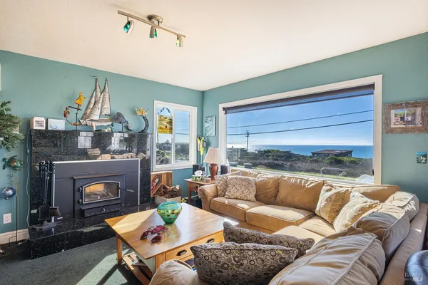 a living room with furniture and view of kitchen