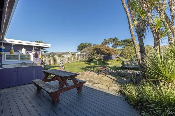a view of backyard of house with green space