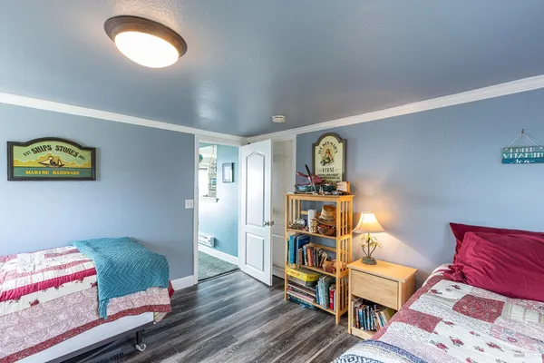 a utility room with lots of clutter and refrigerator