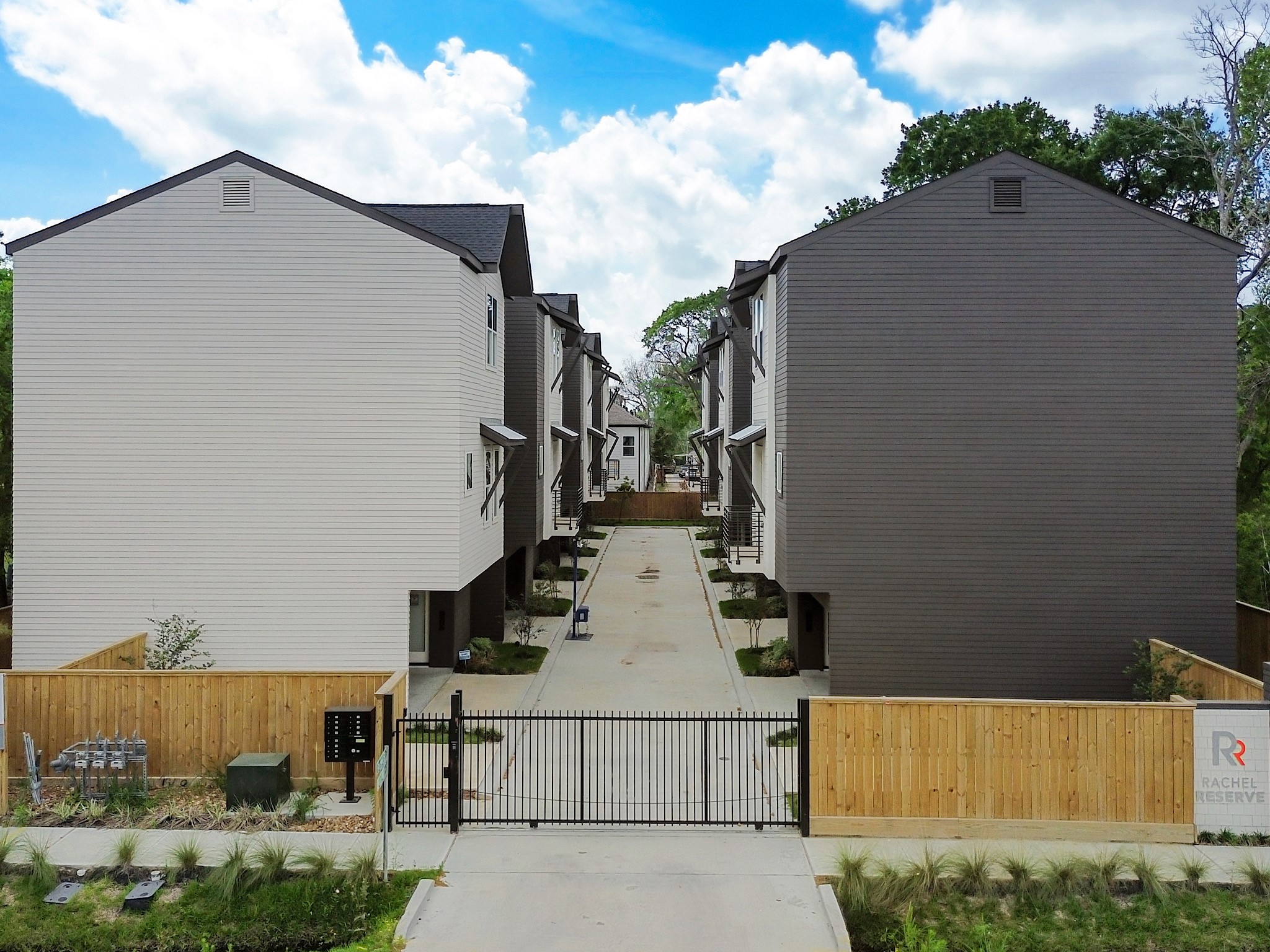 861 Rachel Street, Unit E Houston, TX 77091 - Photo 28 of 29 Discover a modern, gated community offering sleek, contemporary townhomes nestled amidst lush greenery, perfect for those seeking style and security.