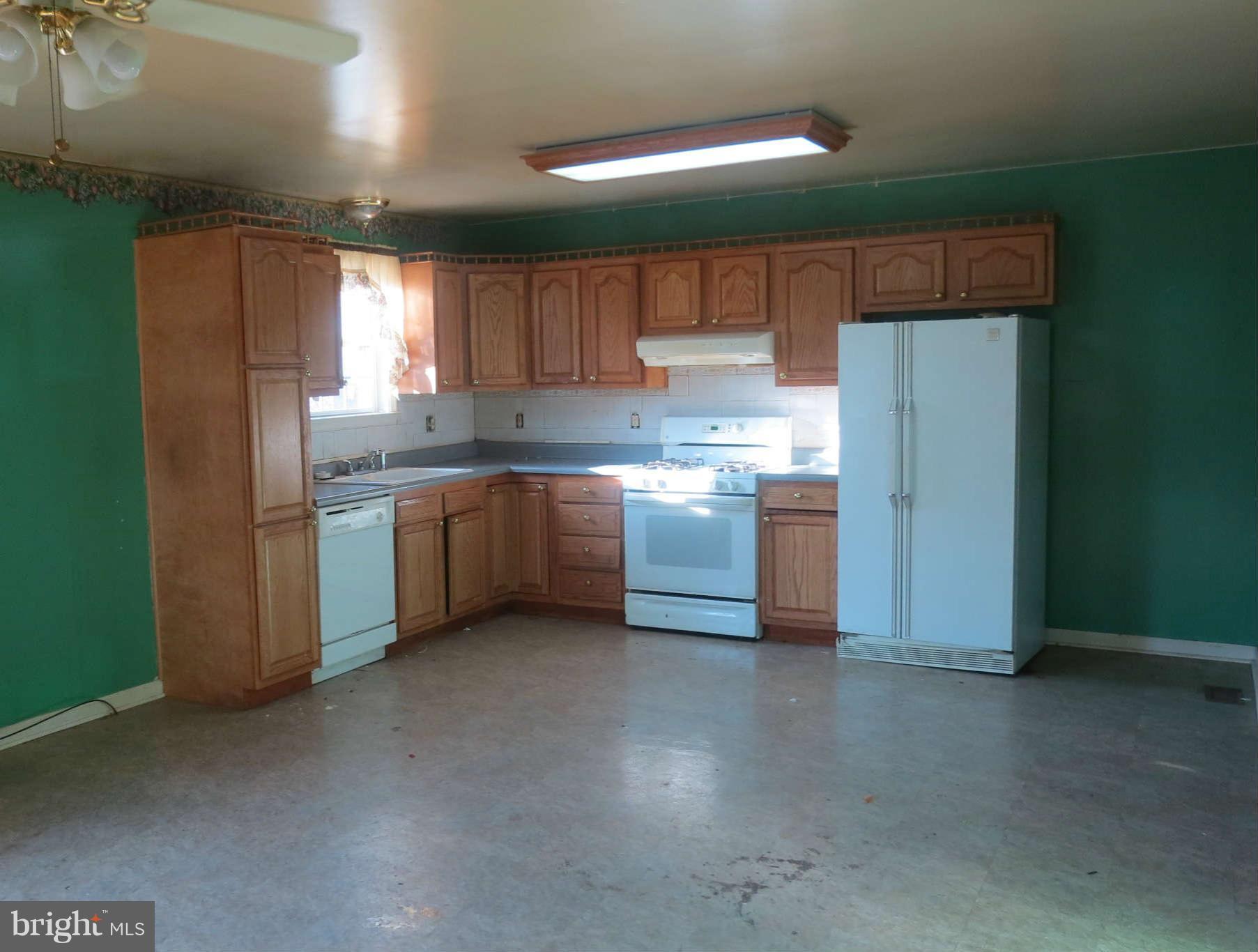 4814 Valley Forge Road Randallstown, MD 21133 - Photo 2 of 16 a kitchen with stainless steel appliances a sink cabinets and a refrigerator