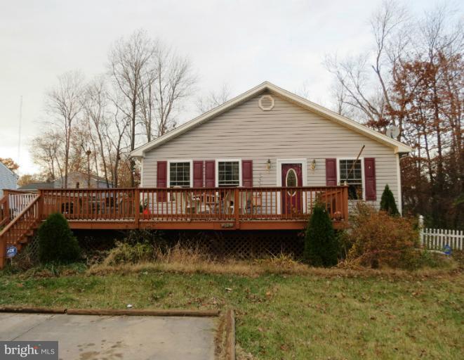 4814 Valley Forge Road Randallstown, MD 21133 - Photo 13 of 16 a view of a house with a small yard and a wooden deck