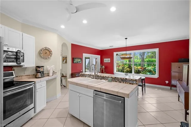 a kitchen with stainless steel appliances granite countertop a sink and cabinets
