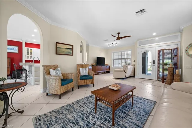 a living room with furniture a table and a flat screen tv