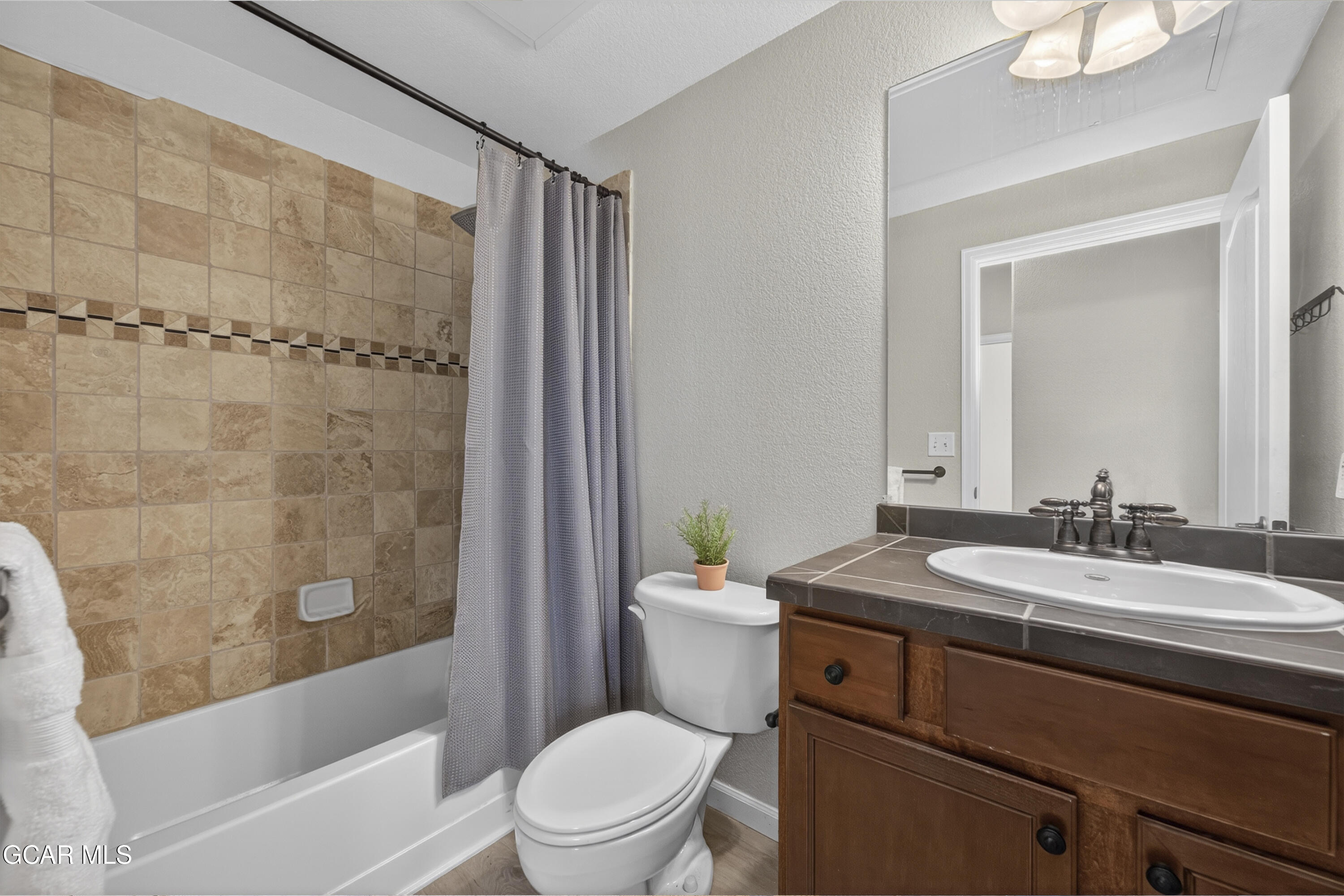 158 Village Road Granby, CO 80446 - Photo 21 of 46 a bathroom with a sink a toilet a mirror a bathtub and shower