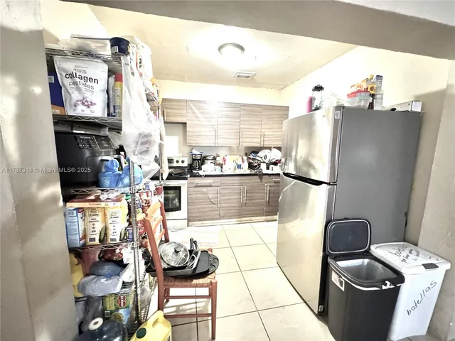 a kitchen with a refrigerator and a stove