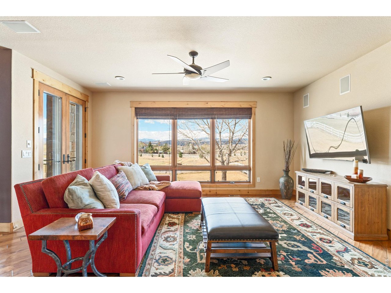 3032 Center Ridge Drive Berthoud, CO 80513 - Photo 12 of 44 The gathering space adjacent to the deck creates a cohesive indoor-outdoor flow.