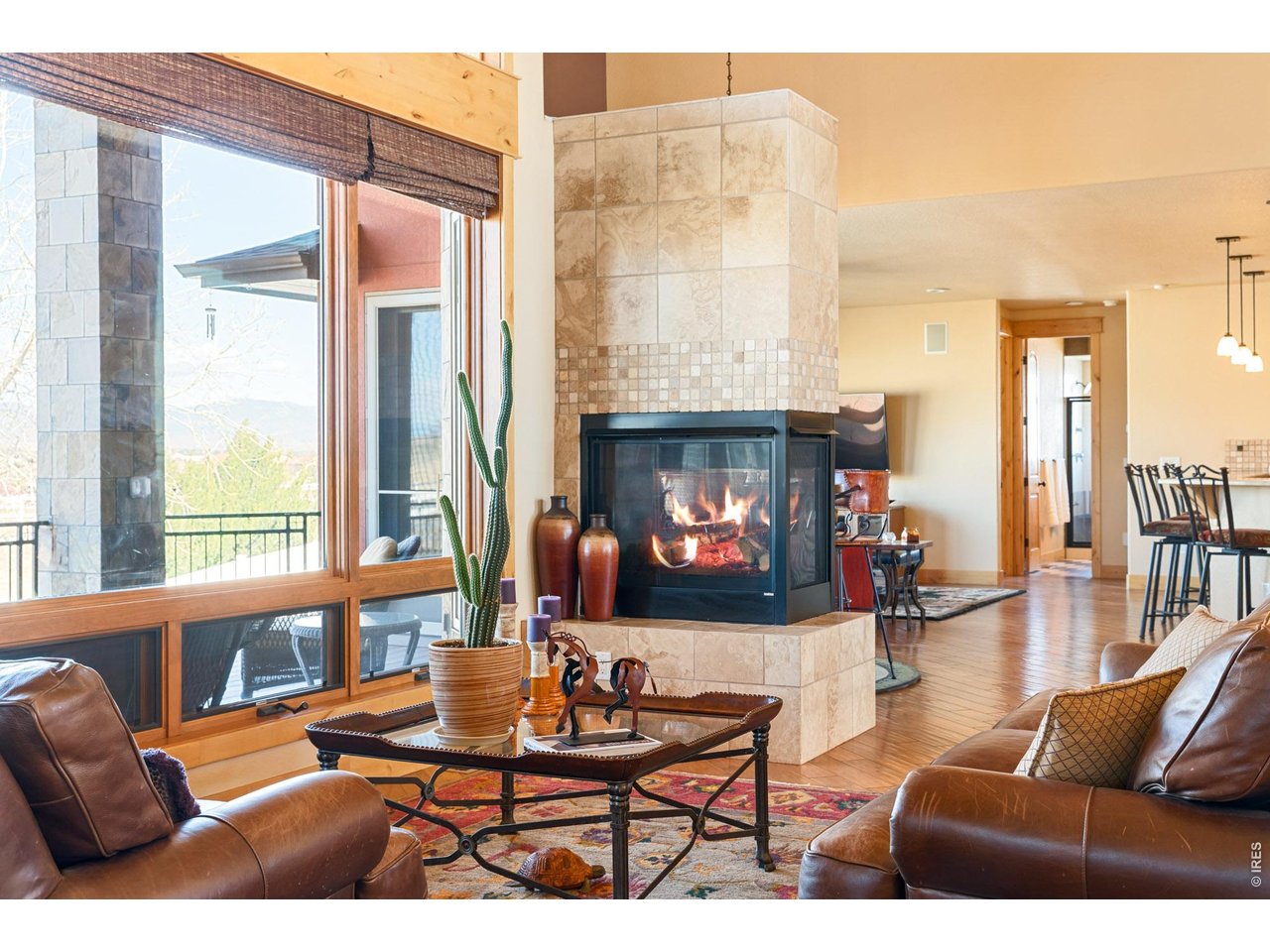 3032 Center Ridge Drive Berthoud, CO 80513 - Photo 3 of 44 A striking two-sided fireplace elegantly defines the space while creating a warm, intimate ambiance.
