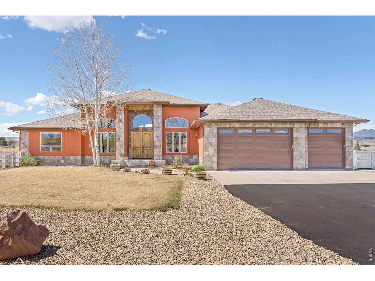 3032 Center Ridge Drive Berthoud, CO 80513 - Photo 4 of 44 Stone column entrance and oversized 3-car garage.