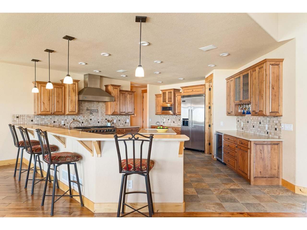 3032 Center Ridge Drive Berthoud, CO 80513 - Photo 7 of 44 The wraparound kitchen counter creates a natural gathering space for entertaining.