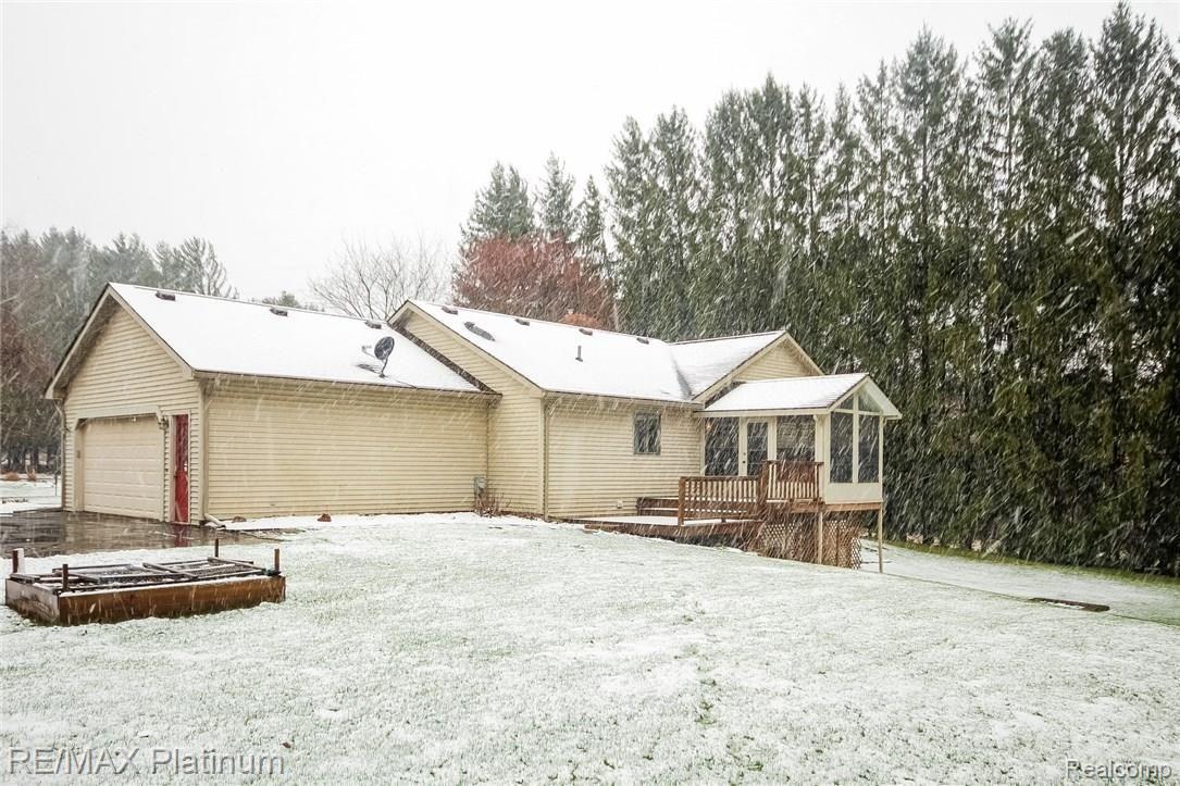 4047 Timberview Drive Howell, MI 48843 - Photo 53 of 59 Raised garden area- notice the huge pines on far side of yard