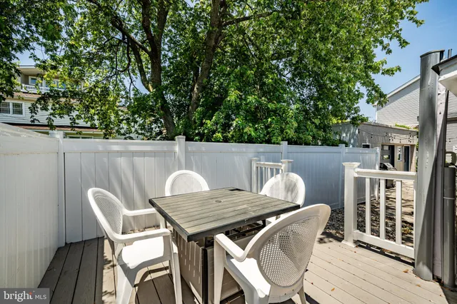 a view of balcony with wooden floor and outdoor seating