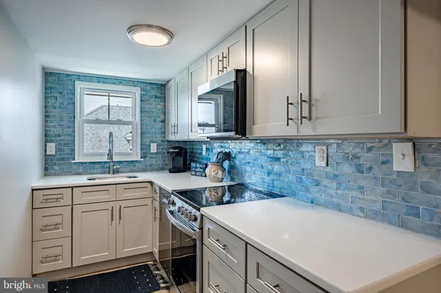 a kitchen with a sink cabinets and window
