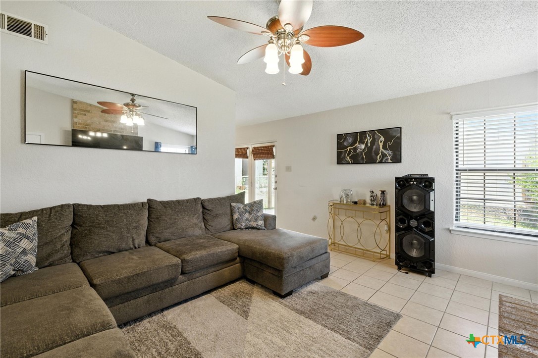 127 Jordan Loop Nolanville, TX 76559 - Photo 4 of 18 a living room with furniture and a flat screen tv
