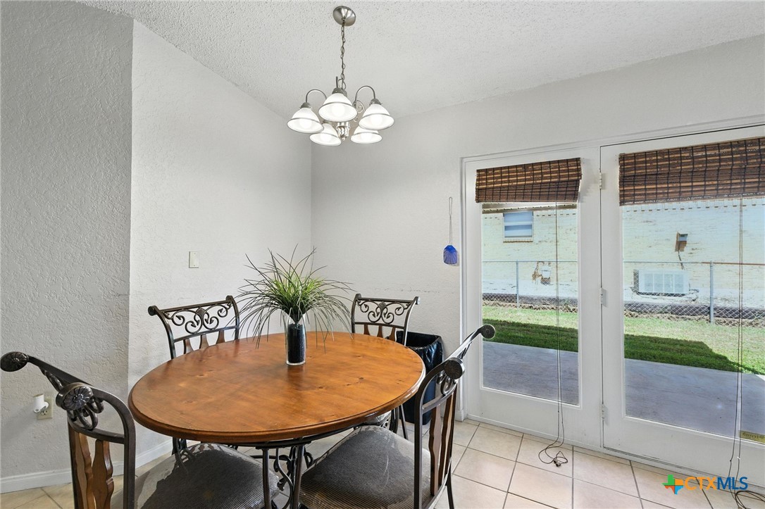 127 Jordan Loop Nolanville, TX 76559 - Photo 8 of 18 a view of a dining room with furniture and chandelier