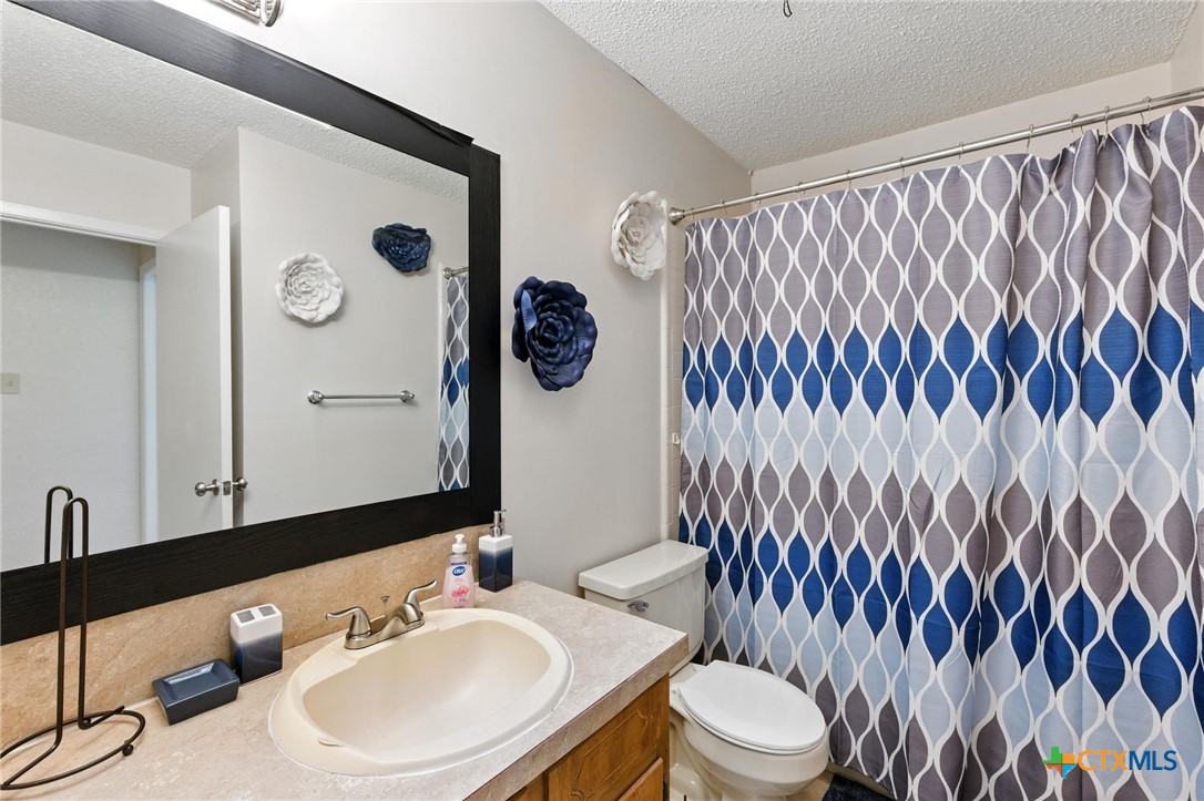 127 Jordan Loop Nolanville, TX 76559 - Photo 9 of 18 a bathroom with a sink and a mirror