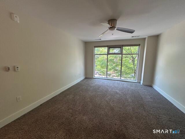 111 Morgan Street, Unit TH5 Stamford, CT 06905 - Photo 14 of 23 an empty room with a ceiling fan and a window