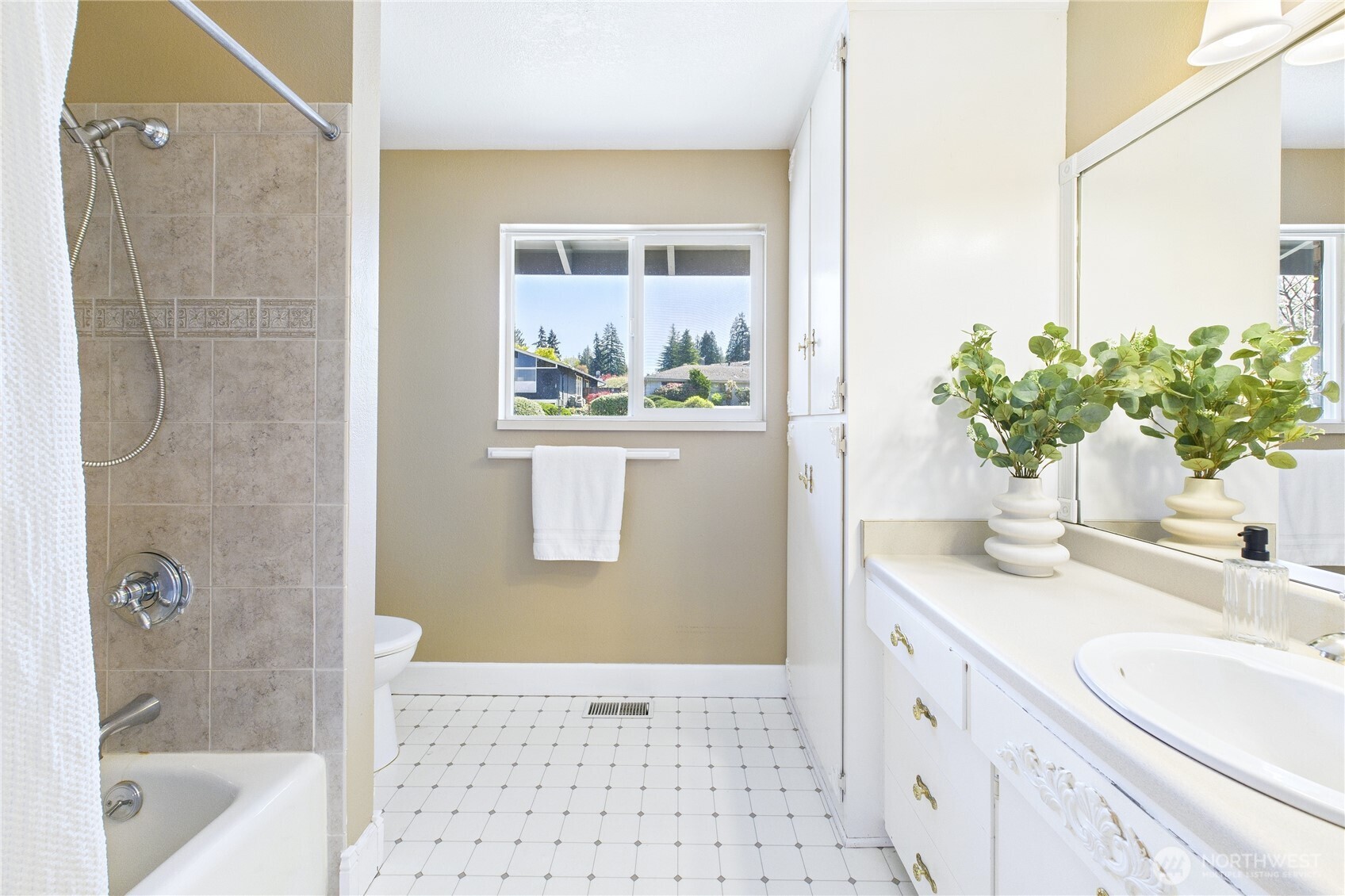 1323 121st Avenue Southeast Bellevue, WA 98005 - Photo 12 of 28 a bathroom with a granite countertop sink a mirror and a bathtub