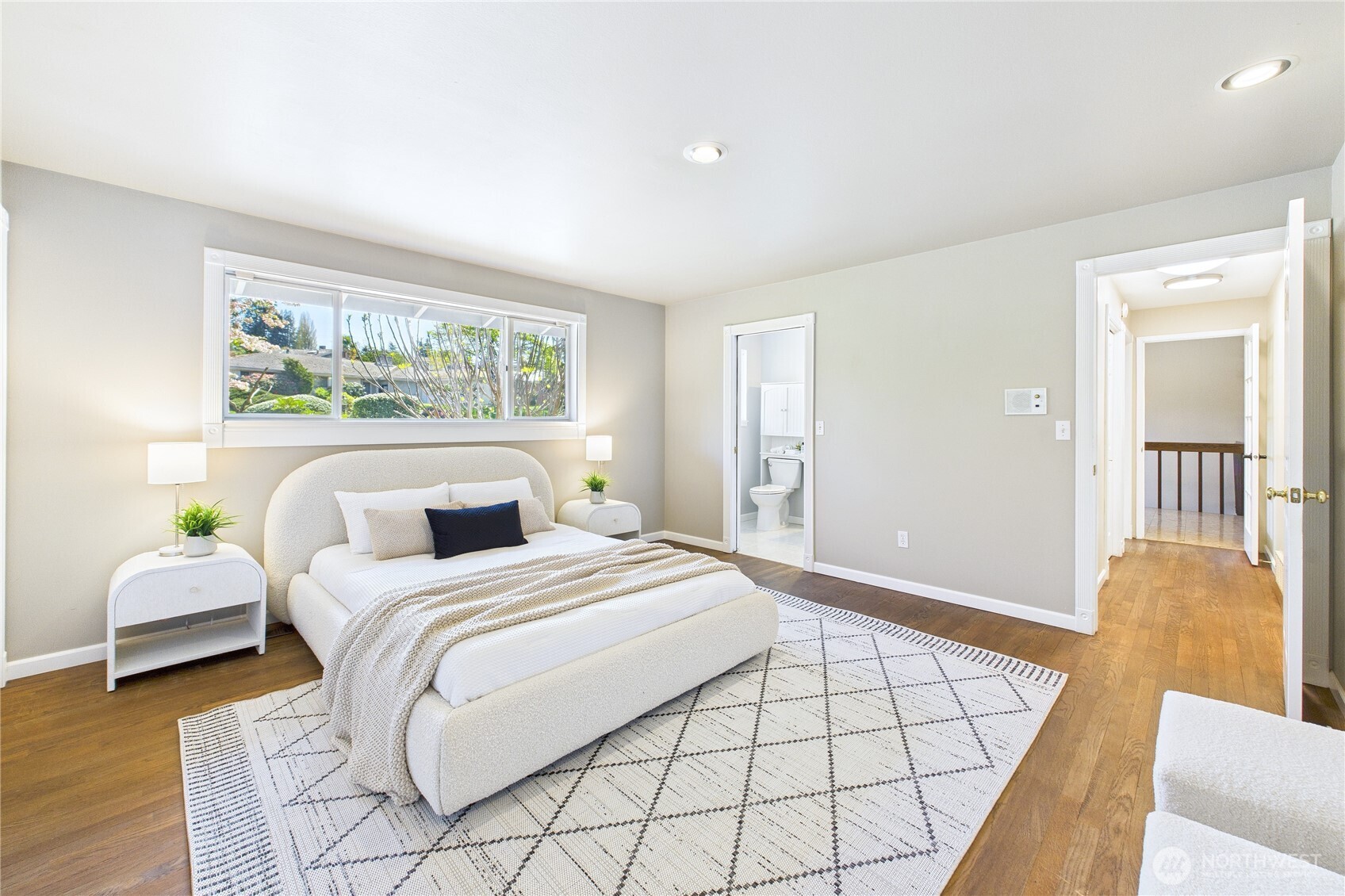 1323 121st Avenue Southeast Bellevue, WA 98005 - Photo 14 of 28 a bedroom with a bed and wooden floor