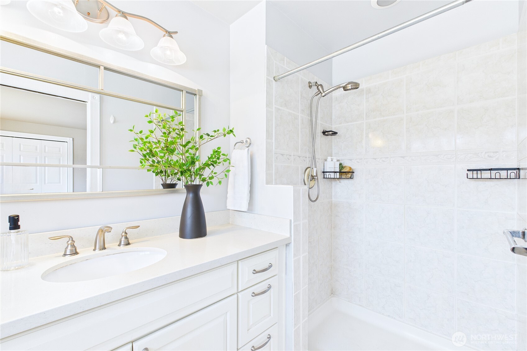 1323 121st Avenue Southeast Bellevue, WA 98005 - Photo 15 of 28 a bathroom with a sink a faucet a potted plant and a shower
