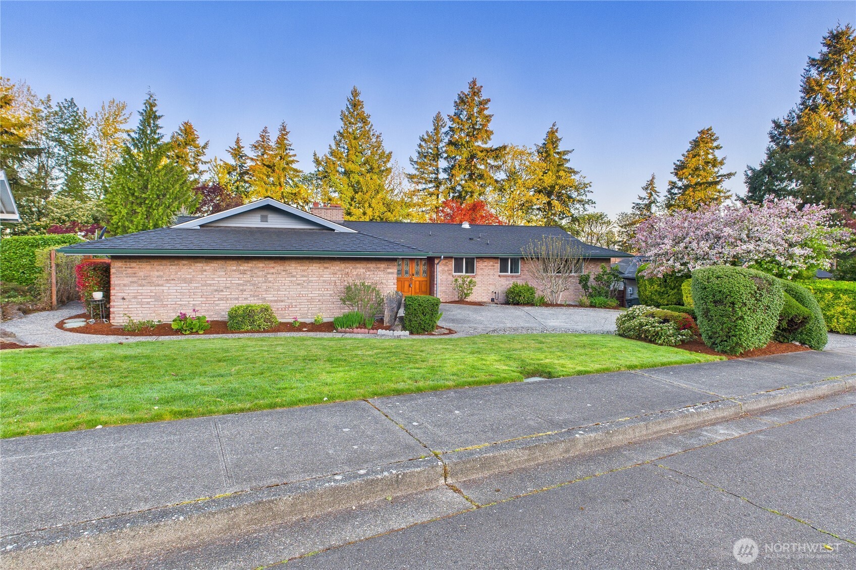 1323 121st Avenue Southeast Bellevue, WA 98005 - Photo 2 of 28 a front view of a house with a yard and garage