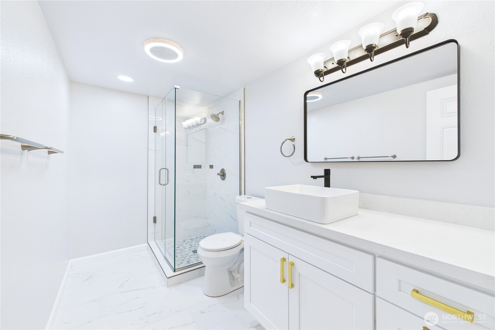 1323 121st Avenue Southeast Bellevue, WA 98005 - Photo 22 of 28 a bathroom with a sink a toilet and shower