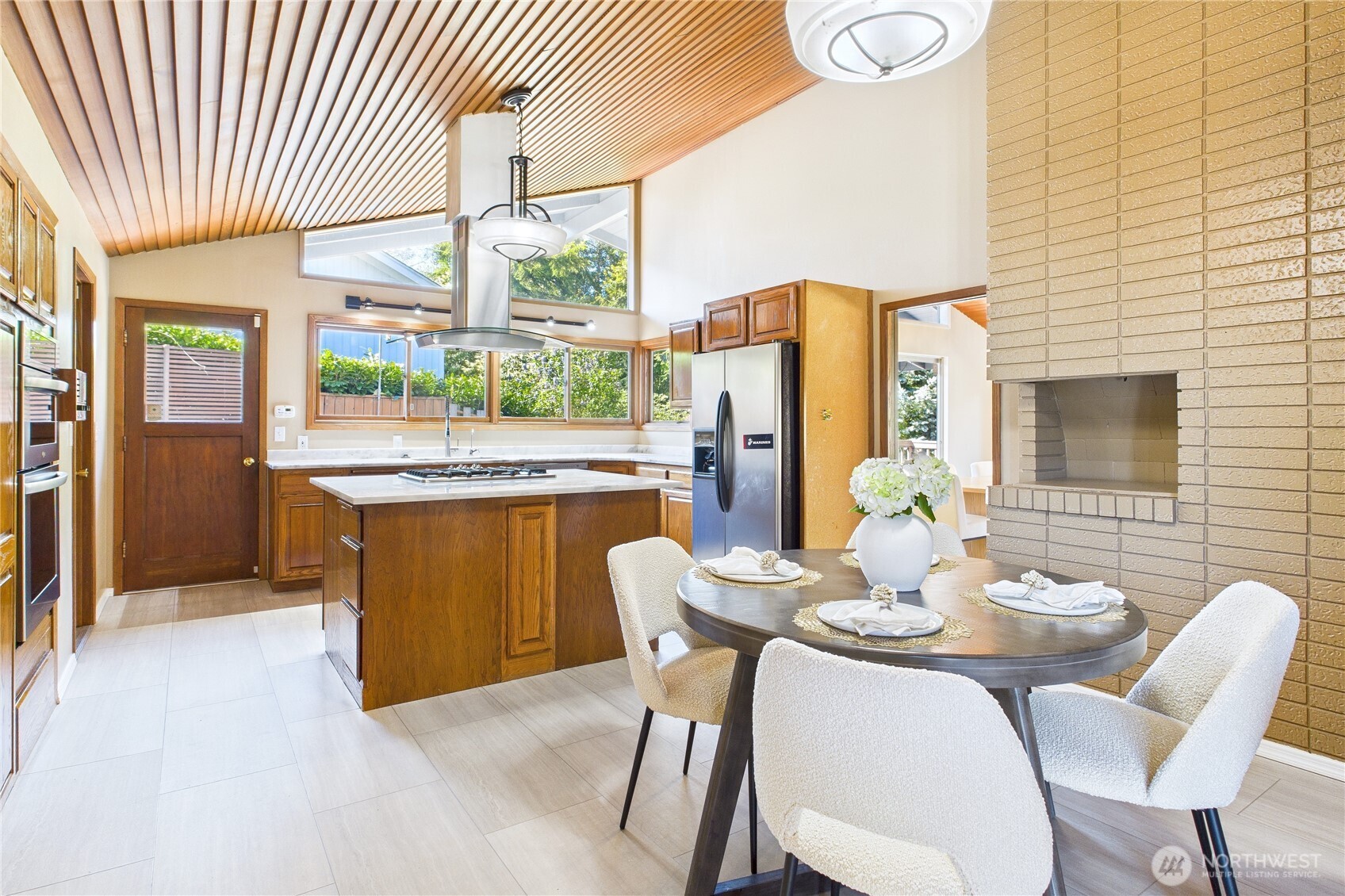 1323 121st Avenue Southeast Bellevue, WA 98005 - Photo 7 of 28 a dining room with furniture a window and wooden floor