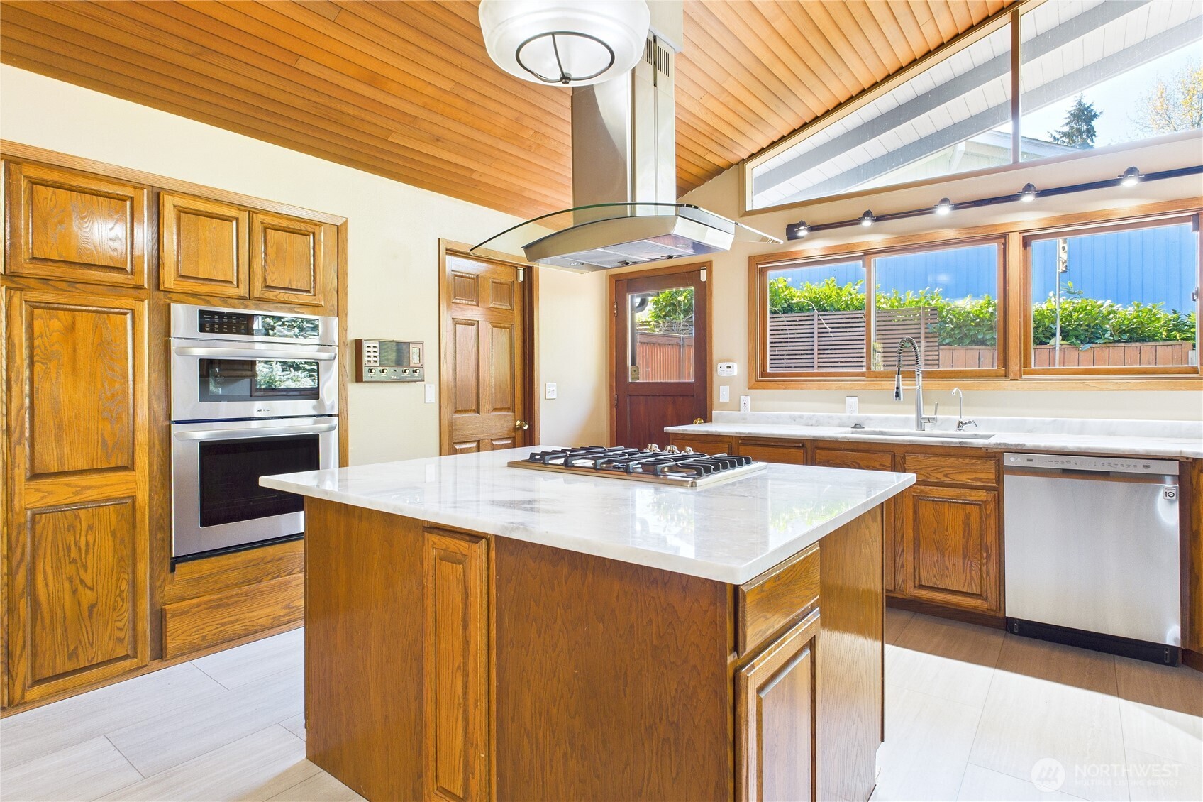 1323 121st Avenue Southeast Bellevue, WA 98005 - Photo 8 of 28 a kitchen with stainless steel appliances granite countertop a sink and a refrigerator