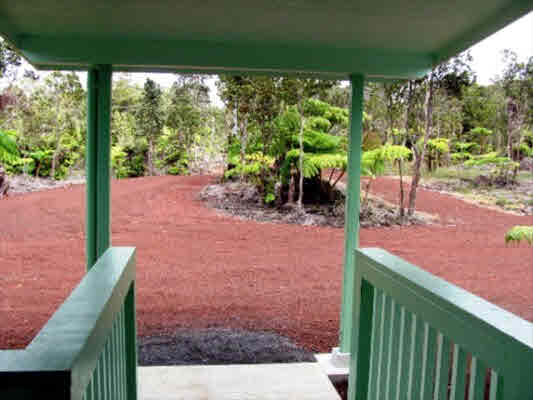 11-2998 Kilikaa Road Volcano, HI 96771 - Photo 3 of 13 a backyard of a house with table and chairs a barbeque with wooden fence