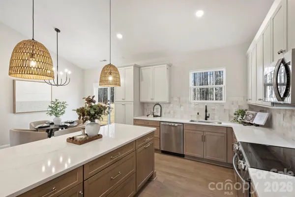 a view of a kitchen sink and a wooden floor