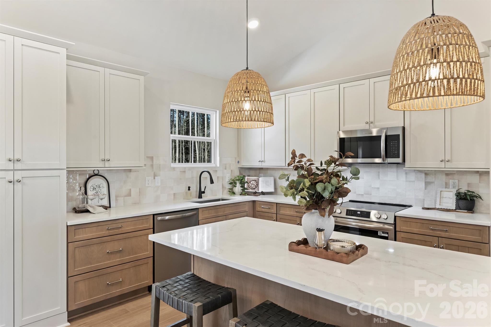 2307 Lee Lawing Road Lincolnton, NC 28092 - Photo 18 of 40 a kitchen with white cabinets and sink