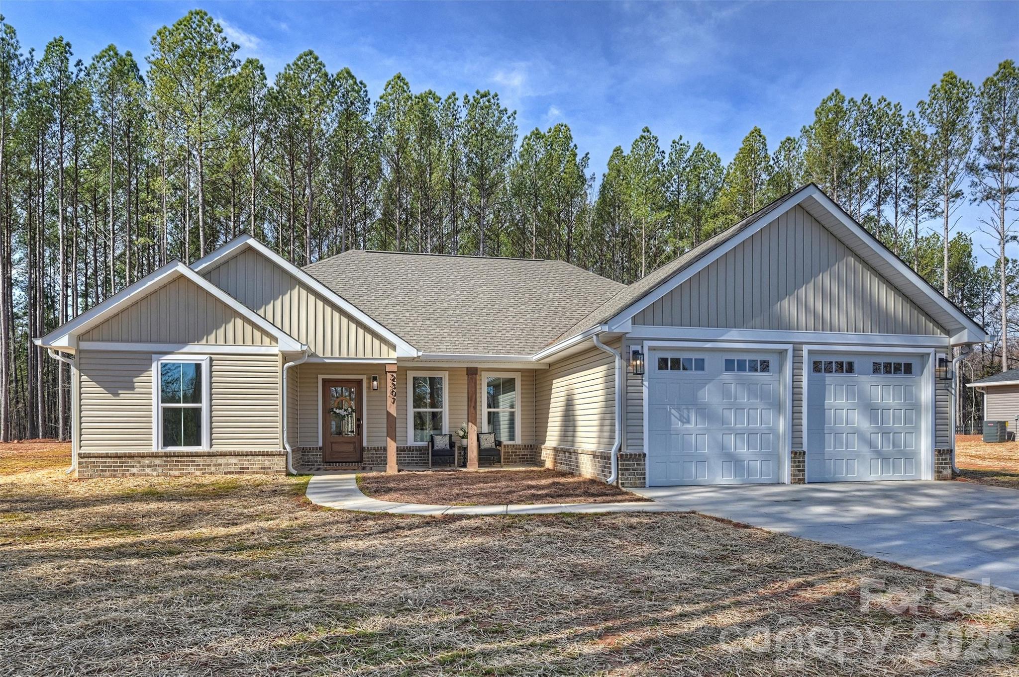 2307 Lee Lawing Road Lincolnton, NC 28092 - Photo 2 of 42 a front view of a house with a yard and trees