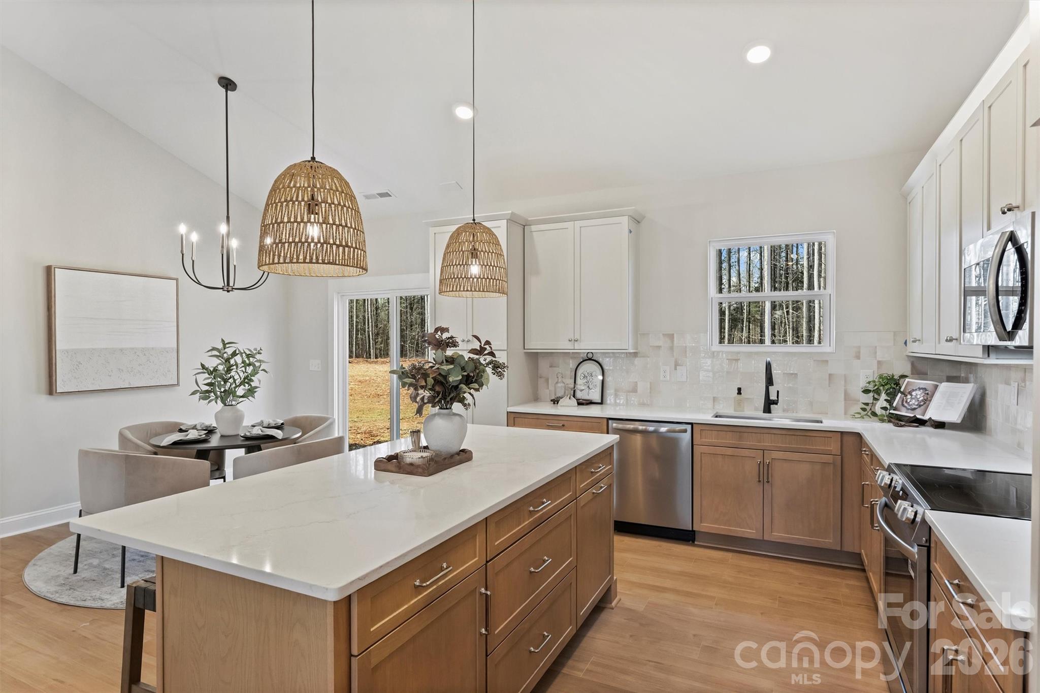 2307 Lee Lawing Road Lincolnton, NC 28092 - Photo 21 of 40 a kitchen with stainless steel appliances a sink a stove center island and chairs