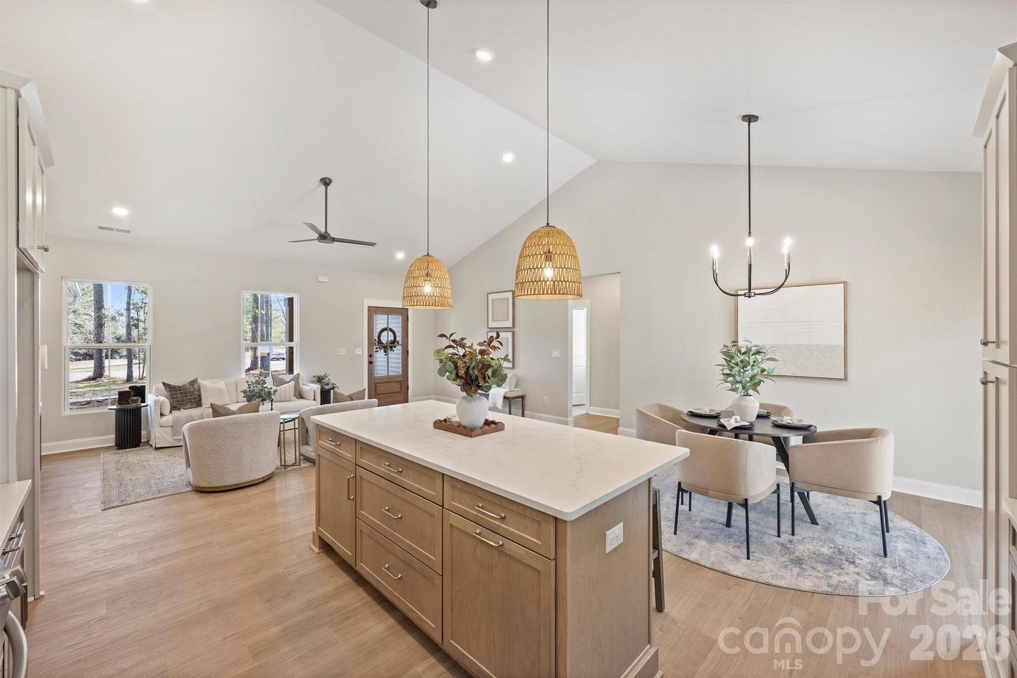 2307 Lee Lawing Road Lincolnton, NC 28092 - Photo 22 of 40 a kitchen with a dining table chairs sink and living room view