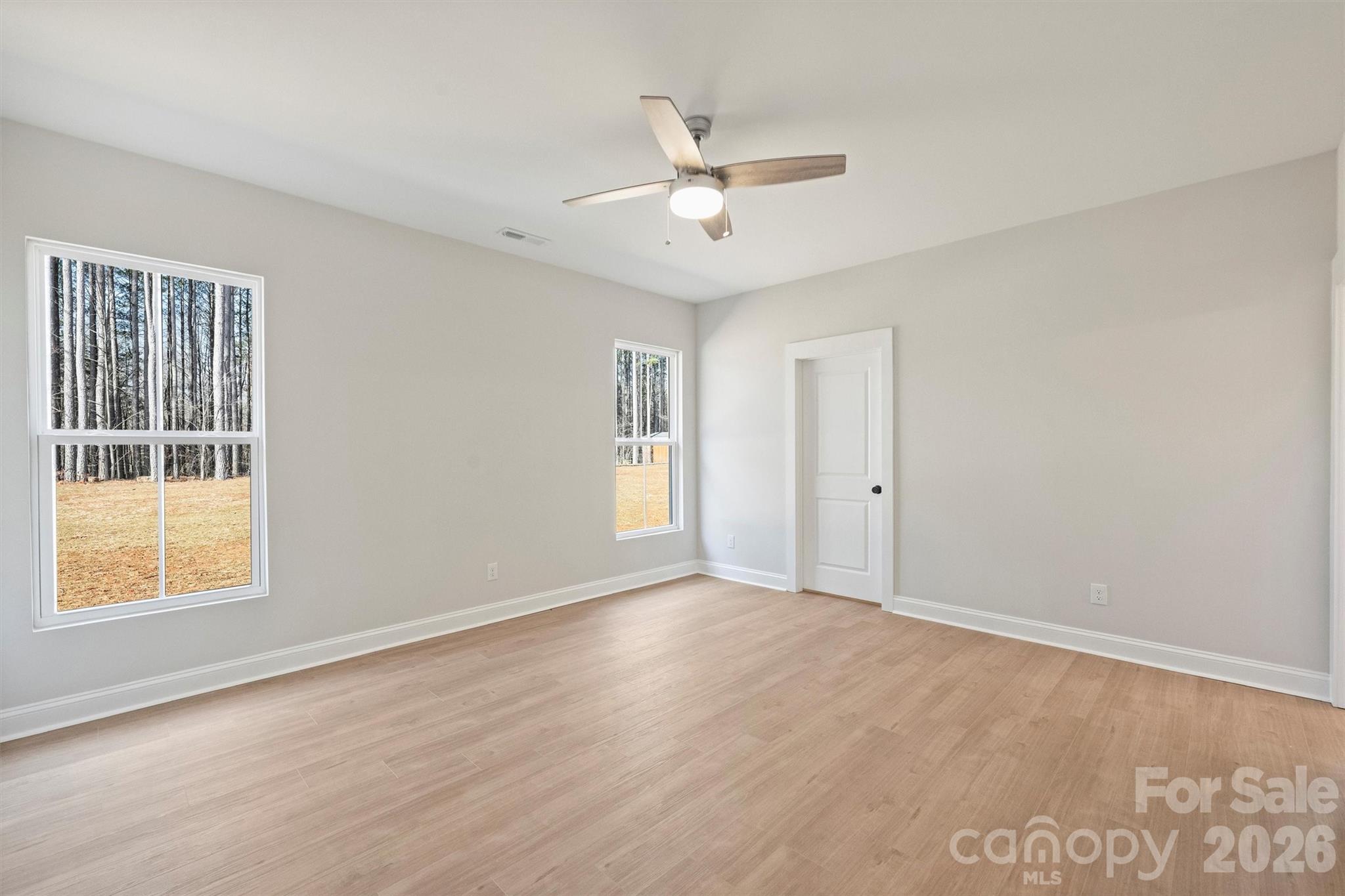 2307 Lee Lawing Road Lincolnton, NC 28092 - Photo 26 of 42 a view of an empty room with wooden floor and a window