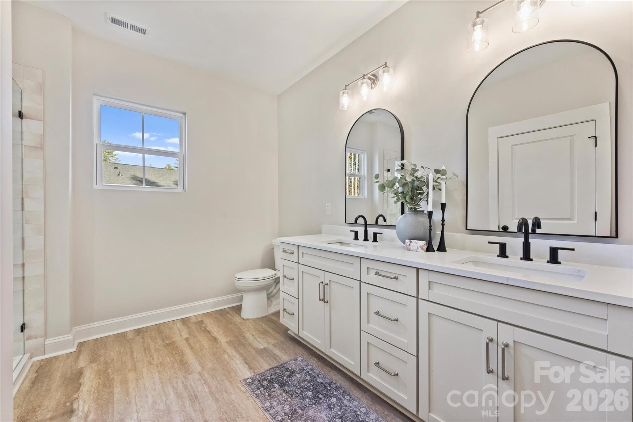 2307 Lee Lawing Road Lincolnton, NC 28092 - Photo 28 of 42 a spacious bathroom with a double vanity sink and a mirror